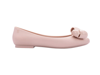 A pair of pink Melissa Doll VIII AD flat shoes with a maxi bow design on the top.