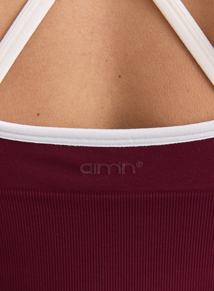 Merlot Shape Seamless Cross Back Bralette showing the ribbed texture, white straps, and glossy aim'n logo. [XS-165cm]