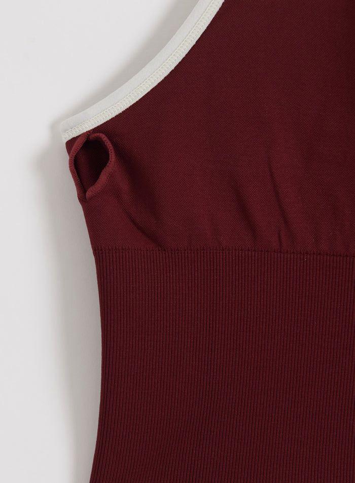 Merlot Shape Seamless Cross Back Bralette by aim'n featuring ribbed fabric and contrast white trim.