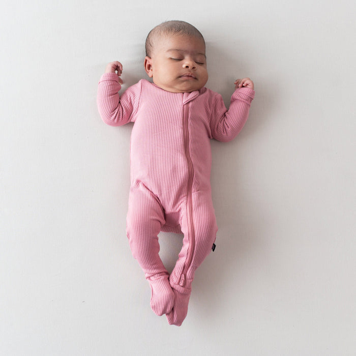 Newborn wearing Ribbed Zipper Footie in Apple Blossom pink