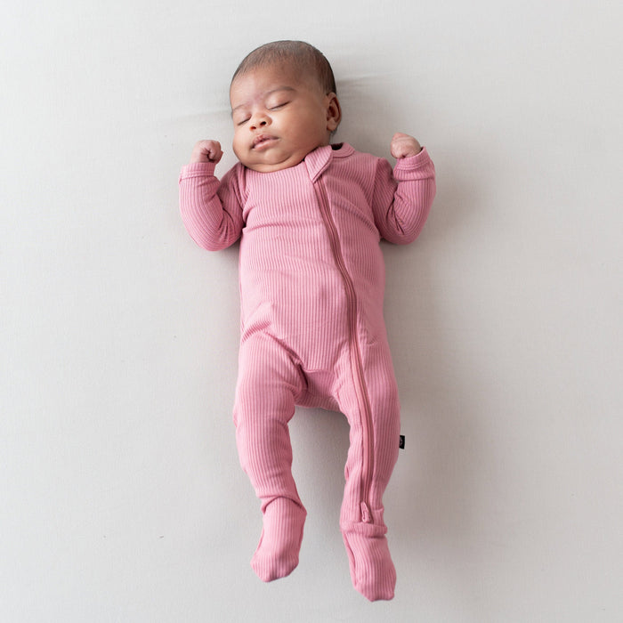 Newborn wearing Ribbed Zipper Footie Pajamas in Apple Blossom
