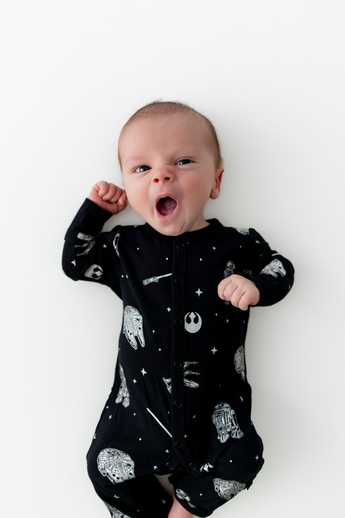 Yawning infant wearing the Romper in STAR WARS™