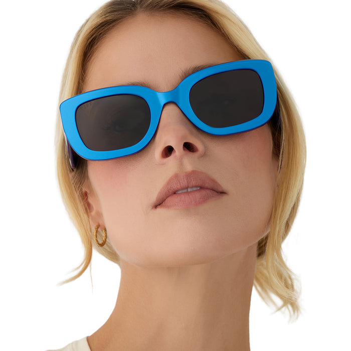 on model - blonde female wearing diff eyewear romy square sunglasses with a luminous blue acetate frame and grey lenses front view