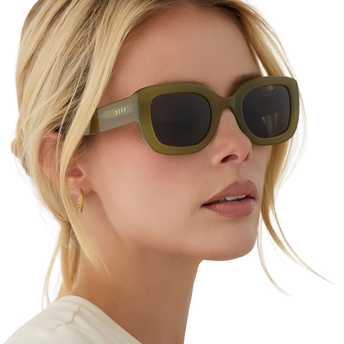 on model - blonde female wearing diff eyewear romy square sunglasses with a sweet pea green acetate frame and grey lenses angled view