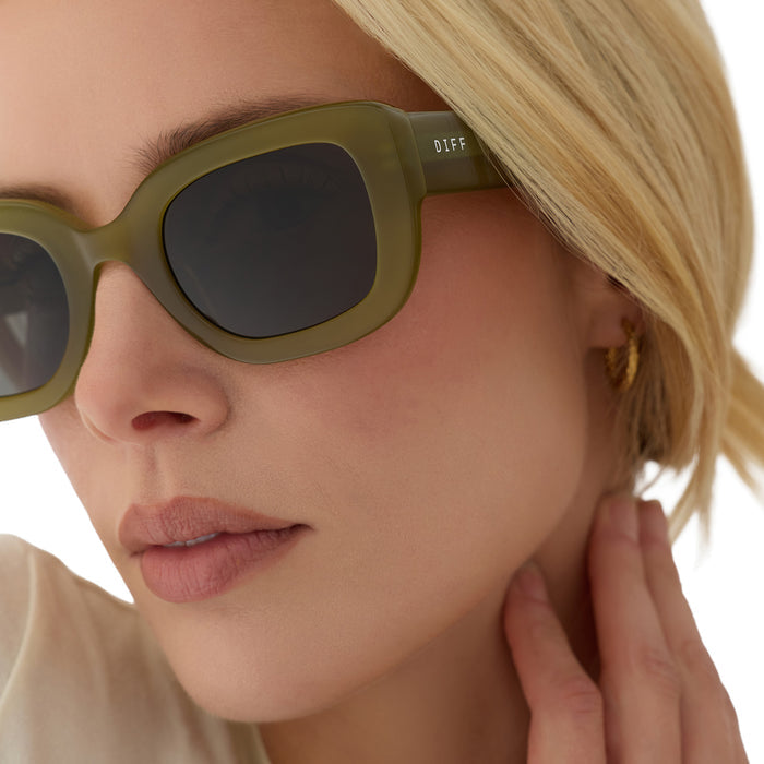 on model - blonde female wearing diff eyewear romy square sunglasses with a sweet pea green acetate frame and grey lenses detailed view