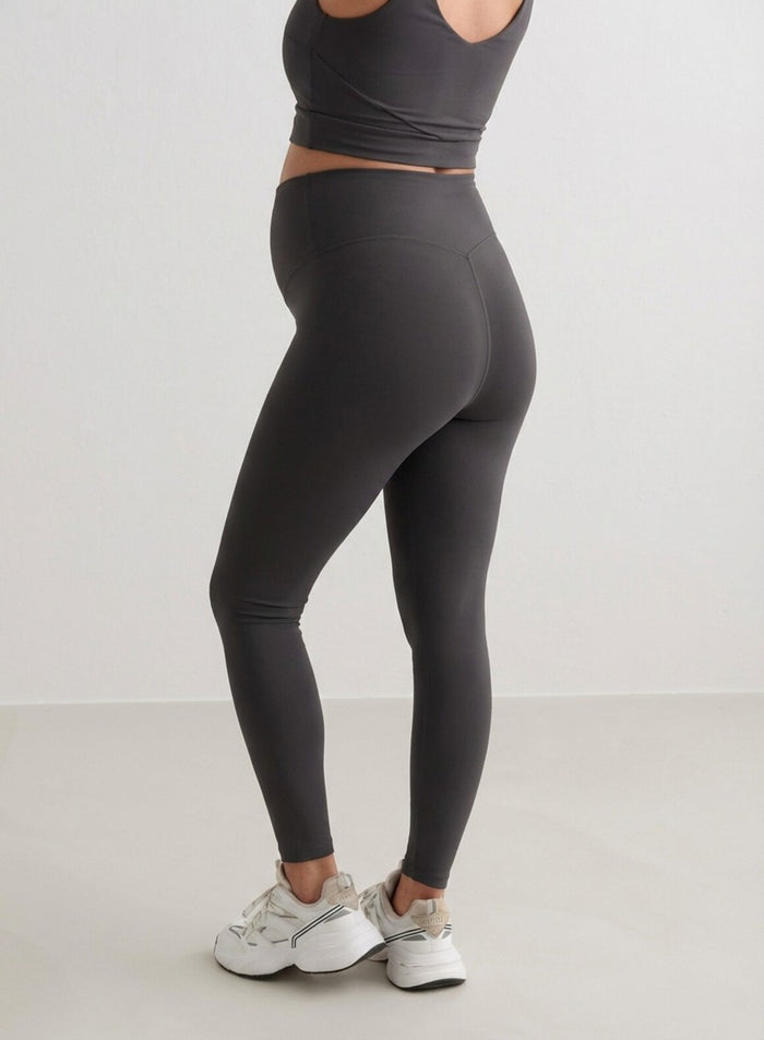 Side view of a woman wearing Shadow Grey Sense Maternity Tights and a matching top from aim'n.