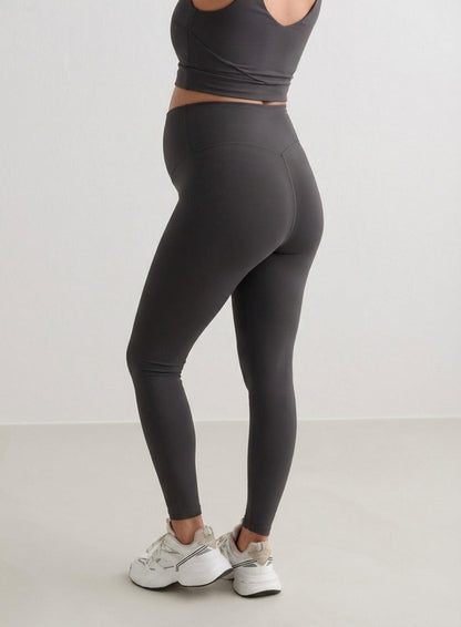 Side view of a woman wearing Shadow Grey Sense Maternity Tights and a matching top from aim'n.