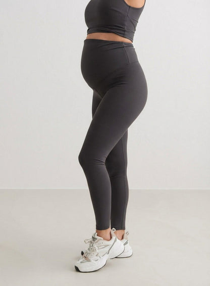 Side profile of a woman wearing Shadow Grey Sense Maternity Tights and a matching top from aim'n.
