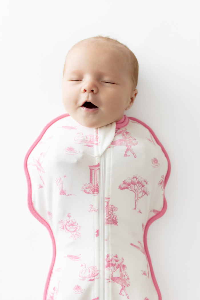 Close up of baby wearing the Swaddle Bag in Toile Ballet 0.5