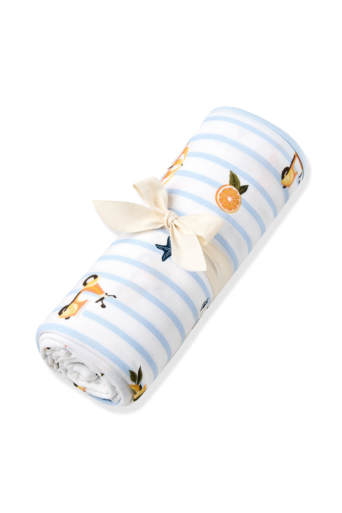 Swaddle Blanket in Amalfi Coast shown rolled in its packaging tied in a bow