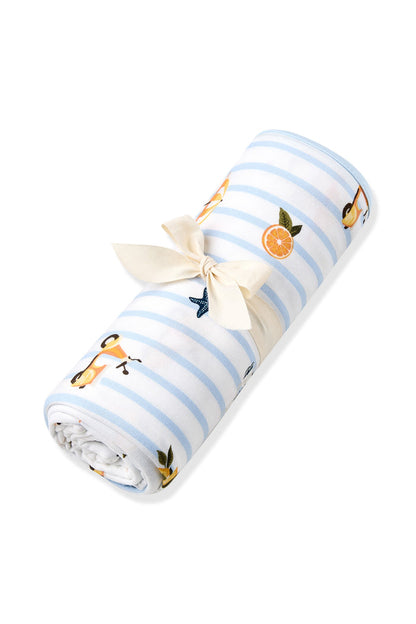 Swaddle Blanket in Amalfi Coast shown rolled in its packaging tied in a bow