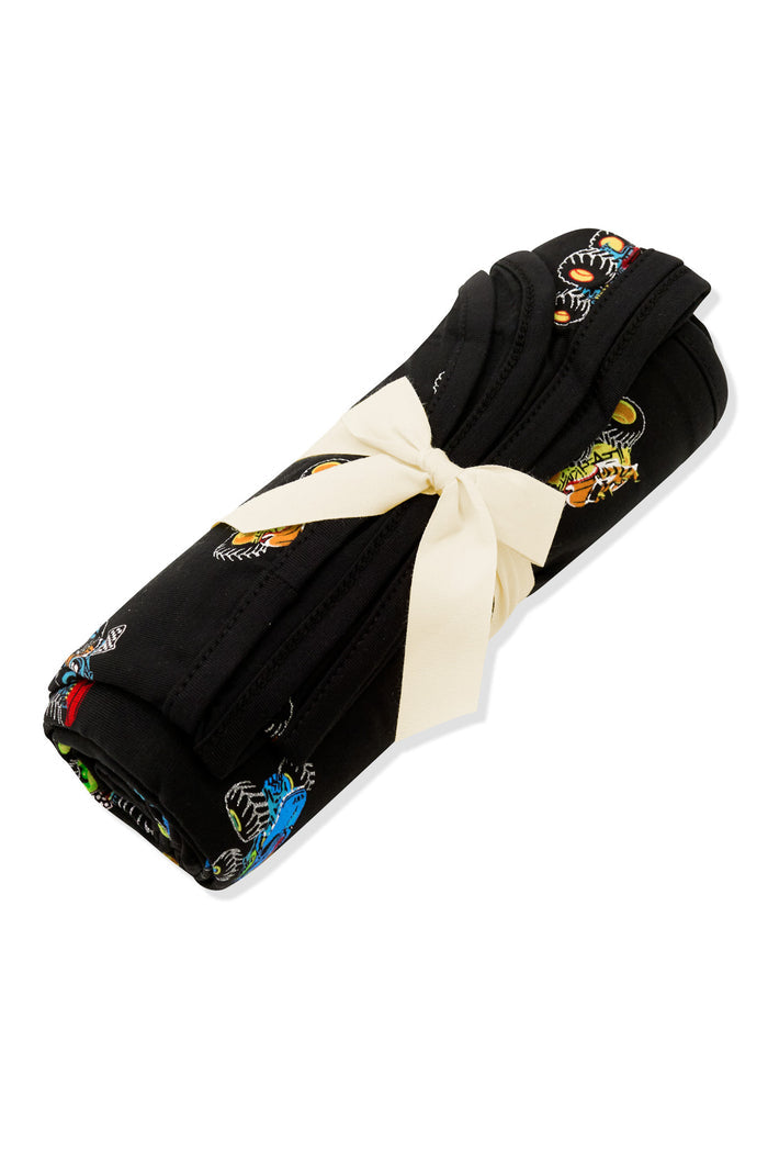 Swaddle Blanket in Monster Truck print rolled up and tied with a ribbon