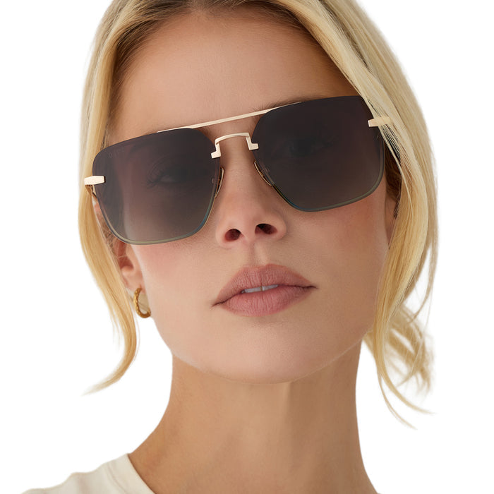 on model - blonde female wearing diff eyewear teddy oversized navigator sunglasses with a gold metal frame and brown gradient polarized lenses front view