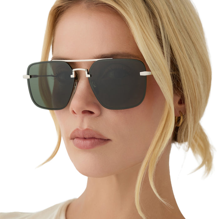 on model - blonde female wearing diff eyewear teddy oversized navigator sunglasses with a silver metal frame and g15 lenses angled view