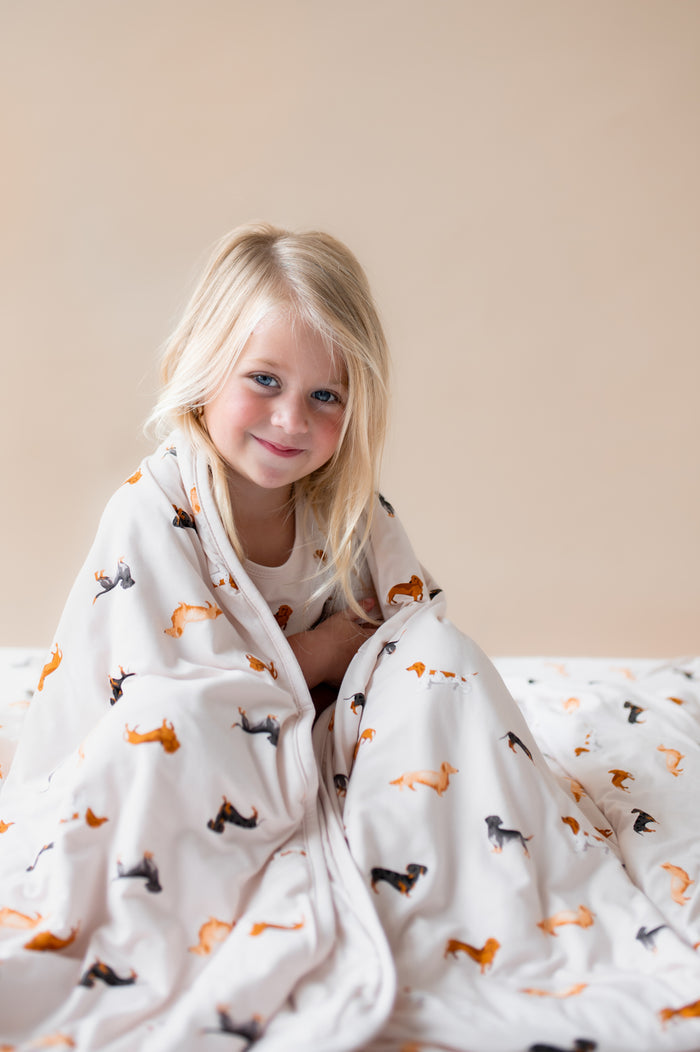 Girl wrapped in a Beige Toddler Blanket in Dachshund print