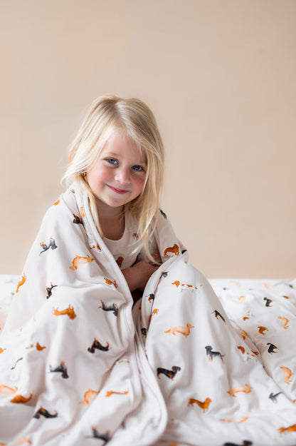 Girl wrapped in a Beige Toddler Blanket in Dachshund print