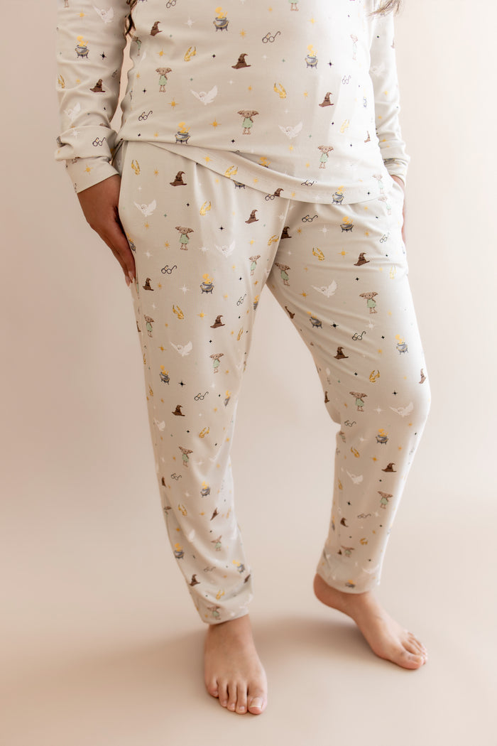 Women showcasing a beige Harry Potter patterned jogger pajama with pocket on a beige background