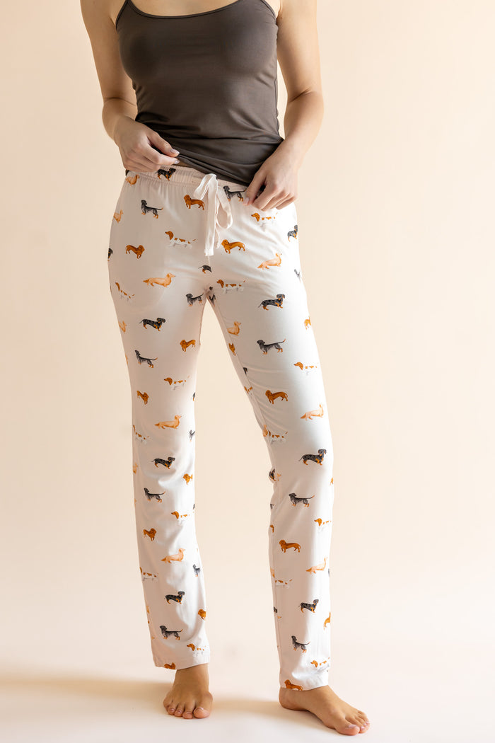 Model showing the drawstring of Women's Lounge Pants in Dachshund print under a brown camisole on a beige background