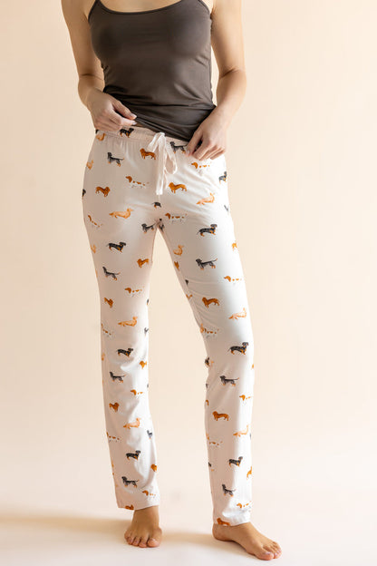 Model showing the drawstring of Women's Lounge Pants in Dachshund print under a brown camisole on a beige background