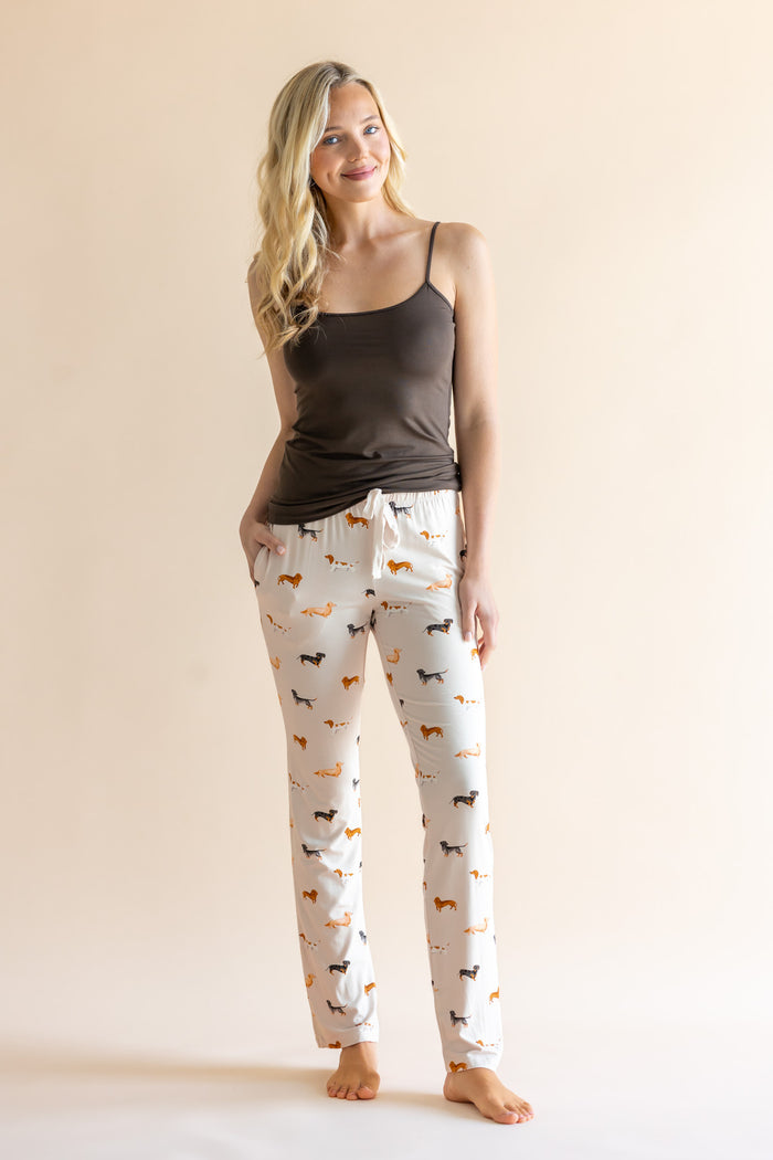 Model wearing Women's Lounge Pants in Dachshund print under a brown camisole on a beige background