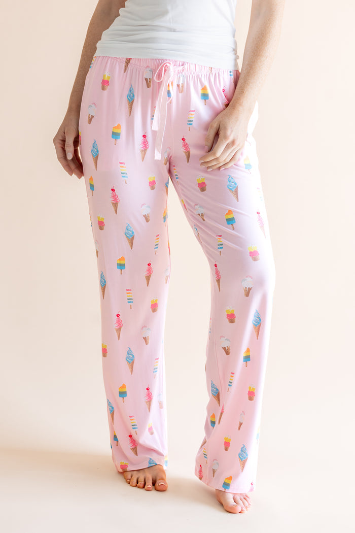 Model in Pink Women's Lounge Pants in Ice Cream print with drawstring under white camisole on beige background