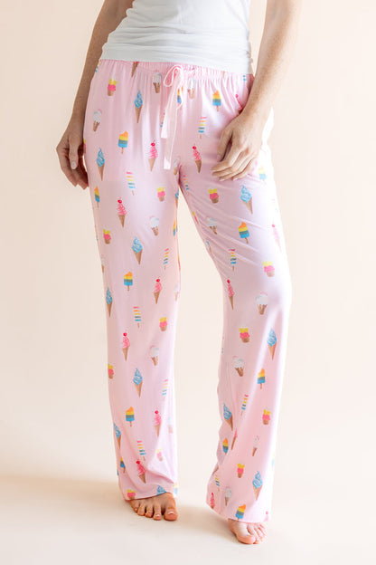 Model in Pink Women's Lounge Pants in Ice Cream print with drawstring under white camisole on beige background