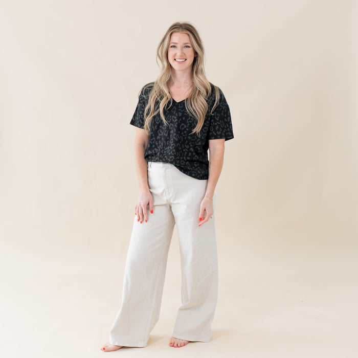 Woman wearing Kyte Baby Women's Relaxed Fit V-Neck tee in Midnight Leopard