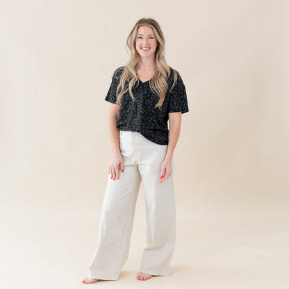 Woman wearing Kyte Baby Women's Relaxed Fit V-Neck tee in Midnight Leopard