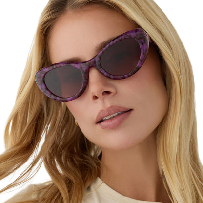 on model - blonde female wearing diff eyewear zaria cat eye sunglasses with a lavender haze purple tortoise acetate frame and brown gradient lenses angled view