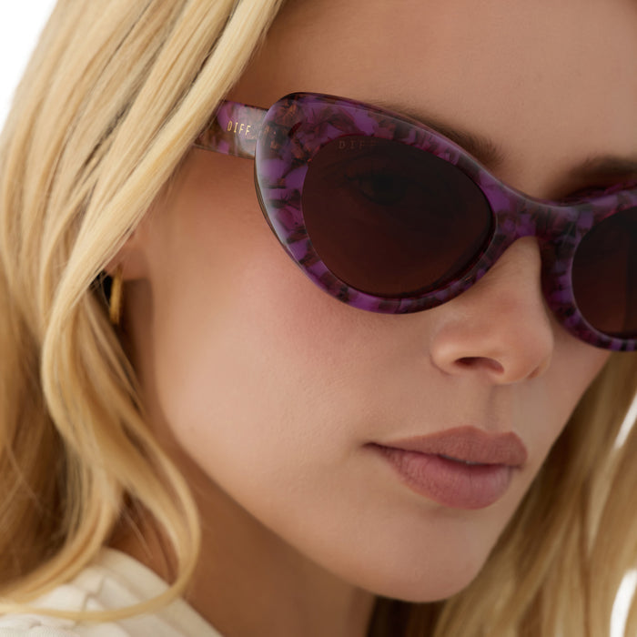 on model - blonde female wearing diff eyewear zaria cat eye sunglasses with a lavender haze purple tortoise acetate frame and brown gradient lenses detailed view