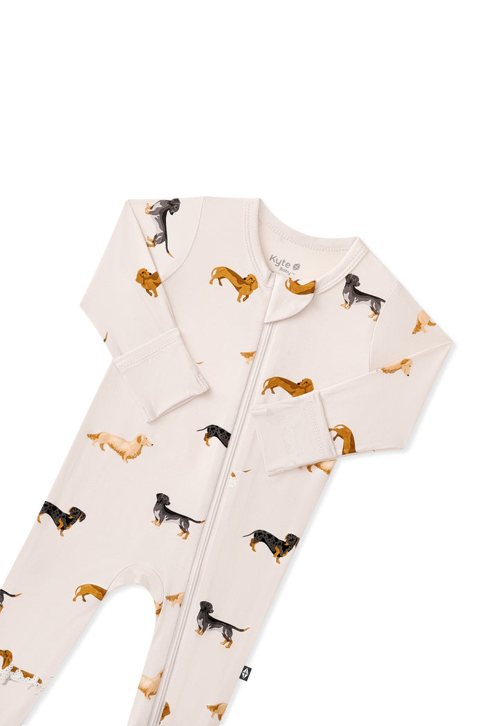 Top part of Beige Zippered Footie in Dachshund print on white background