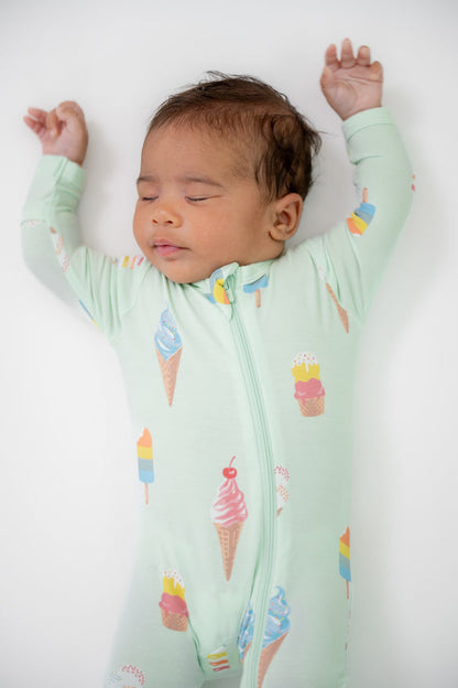 Baby wearing Zippered footie in Mint Ice cream print on a beige background